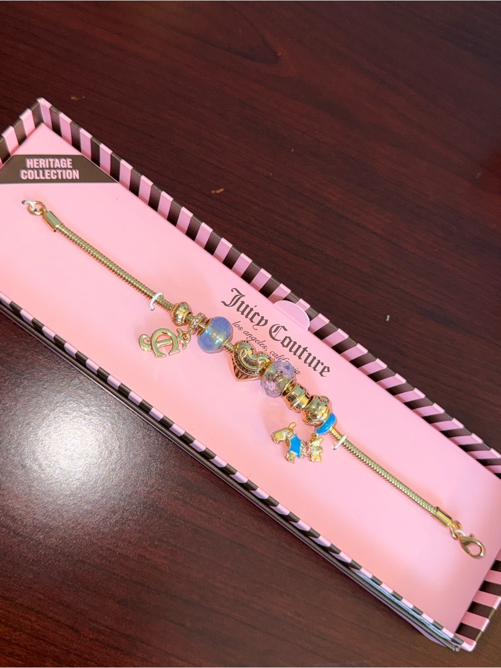 Juicy Couture Gold Charm Bracelet with Blue and Pink Accents